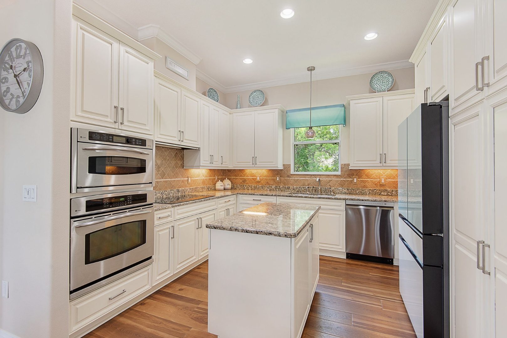 Kitchen with double ovens and granite counters
